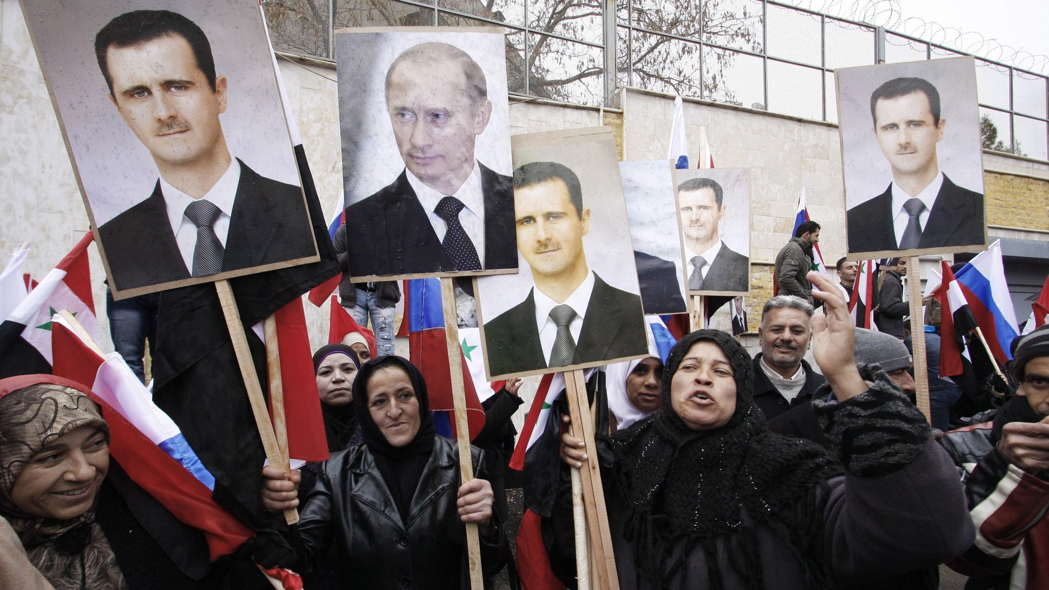Pro-regime demonstrators hold photos of Bashar al-Assad and Vladimir Putin outside Russia embassy in Damascus _ Financal Times.jpg