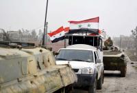 آليات عسكرية وعناصر من قوات النظام السوري - رويترز