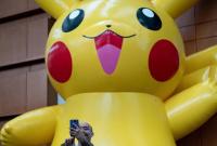رجل يلتقط صورة سيلفي مع شخصية بيكاتشو في أول يوم من بطولة بوكيمون في مركز المؤتمرات بواشنطن- التاريخ 16 آب 2019