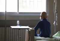 طفل مريض بالسرطان يجلس على سريره في مشفى الأطفال بدمشق - 7 آذار 2022 (AP)