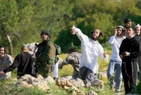 مستوطنون إسرائيليون يلقون الحجارة برفقة جنود الجيش الإسرائيلي في الضفة الغربية المحتلة (الإنترنت)