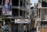 أبنية مدمرة في سوريا ومع ذلك ماتزال صور بشار تنتشر في كل الأرجاء