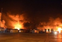 (أرشيف) حريق في ميناء اللاذقية السوري في ديسمبر/ كانون الأول بعد ضربة جوية تواجه إسرائيل اتهامات بتنفيذها