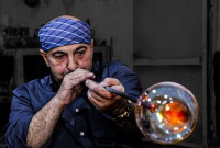 حرفي سوري يعمل بمهنة صناعة الزجاج بالنفخ في دمشق  - سانا