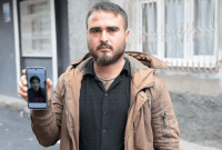 الزوج السوري صالح إسماعيل يحمل صورة زوجته المخطوفة ديلان (İHA)