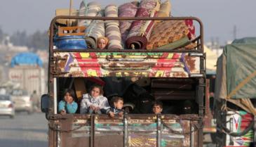 displaced_syrian_children_from_northwest_syria_ride_on_a_back_of_a_truck_with_belongings_in_azaz_syria_january_27_2020._reuters.jpg