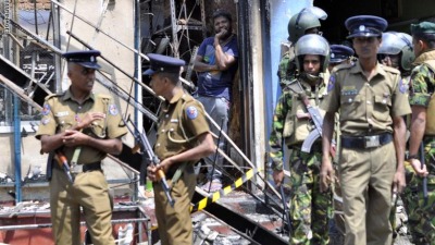 man_looks_out_from_a_burnt_out_home_as_sri_lankan_police_commandos.jpg