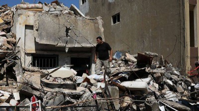 syrian-refugee-ahmed-staifi-walks-among-the-debris-of-a-house-were-his-wife-and-two-of-his-daughters-were-killed-following-a-massive-explosion-in-beirut-6.jpg