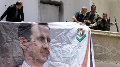 a_banner_displays_the_image_of_syrian_president_bashar_al-assad._afp_file_photo.jpg