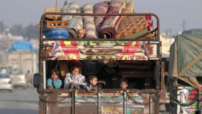 displaced_syrian_children_from_northwest_syria_ride_on_a_back_of_a_truck_with_belongings_in_azaz_syria_january_27_2020._reuters.jpg
