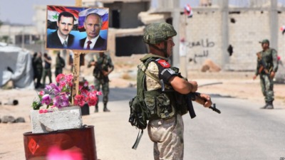 members_of_russian_and_syrian_forces_stand_guard_near_abu_duhur_crossing_on_the_eastern_edge_of_idlib_province_syria_aug_2018.jpg