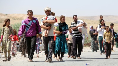عائلات إيزيدية نازحة بعد سيطرة "تنظيم الدولة" على مناطقهم في العراق - AFP