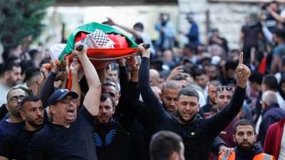 مشيعون يحملون جثمان أحد الفلسطينيين اللذين استشهدا برصاص جنود إسرائيليين في رام الله بالضفة الغربية التي تحتلها إسرائيل.