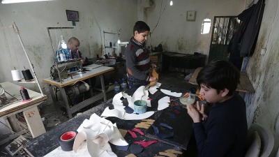 أطفال يعملون في ورشة تصنيع أحذية (أرشيفية/ الأناضول)