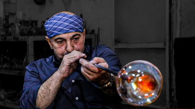 حرفي سوري يعمل بمهنة صناعة الزجاج بالنفخ في دمشق  - سانا